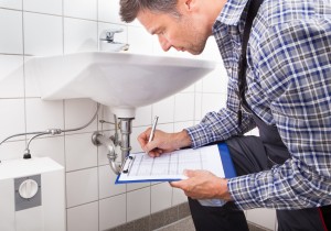 Plumber Writing On Clipboard